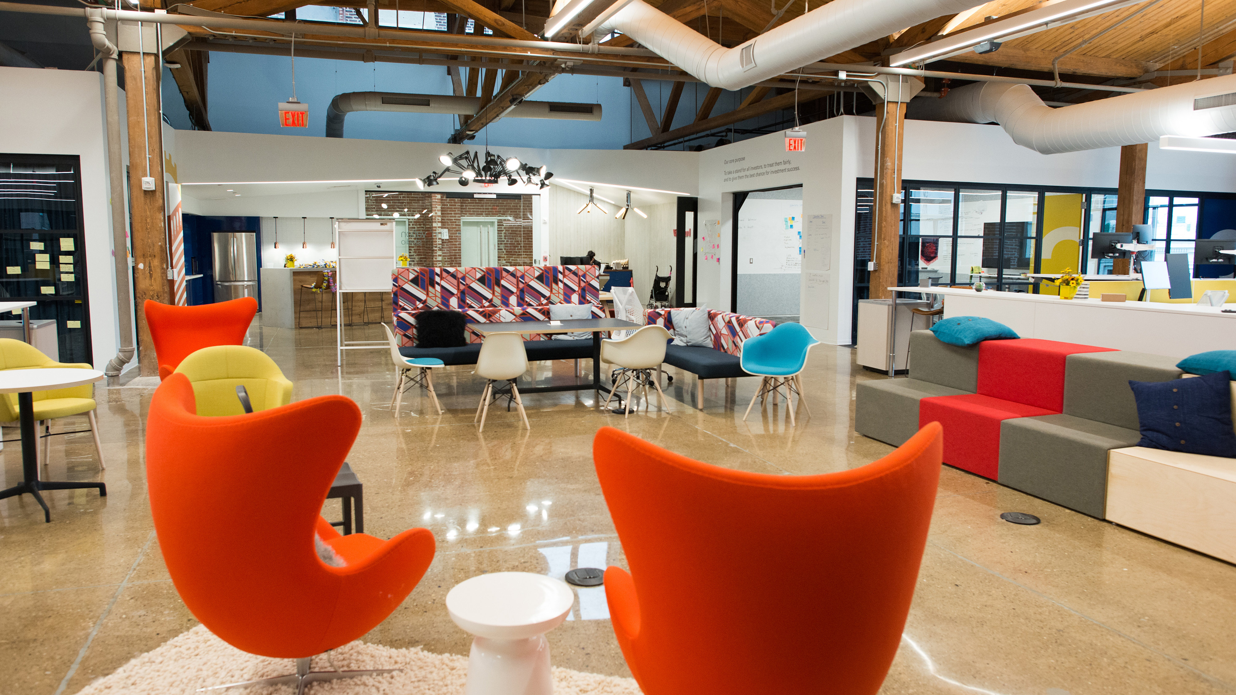 Modern open plan office interior with colourful chairs