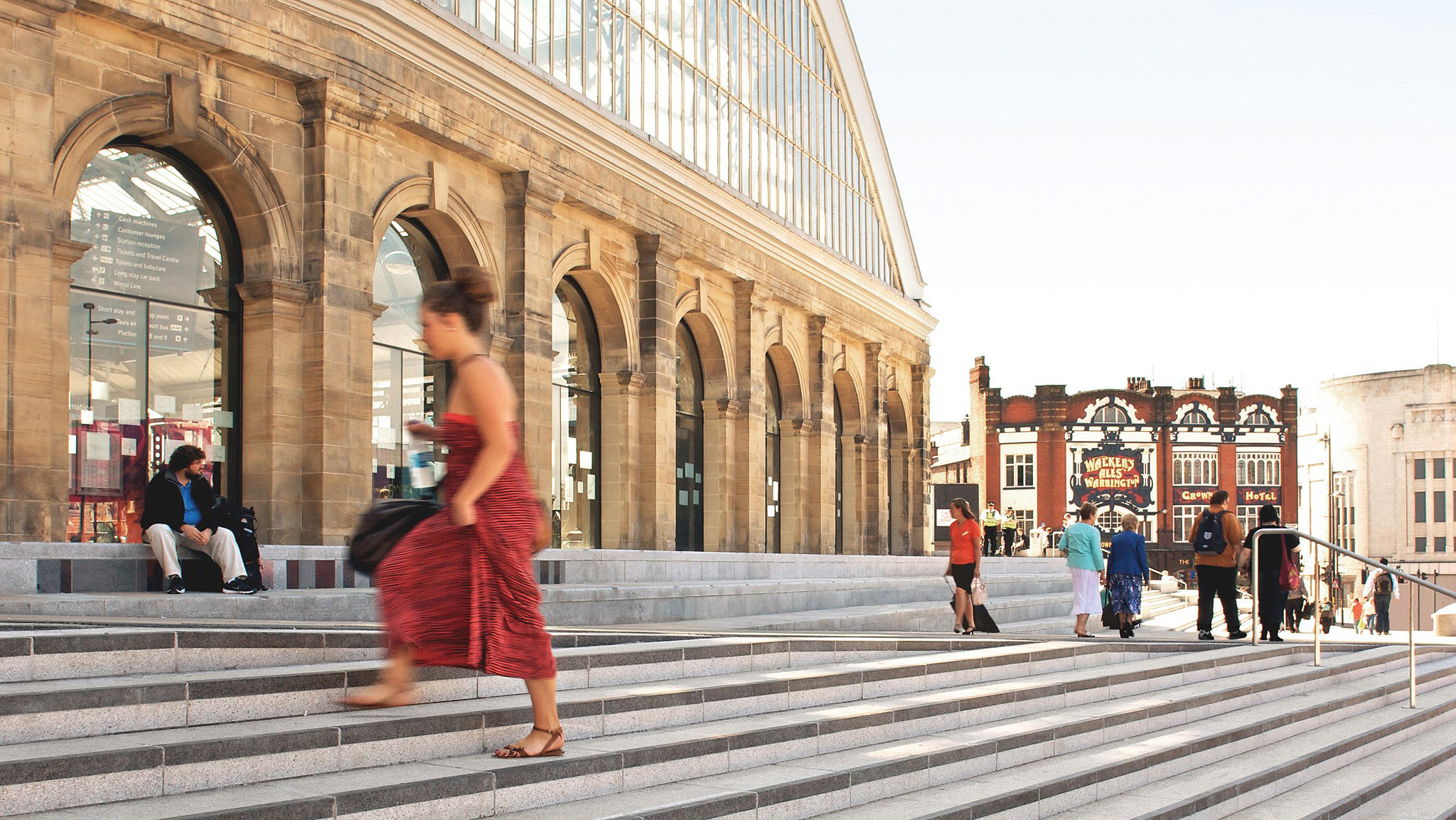 Woman climbing steps to Liverpool's Lime Street station entrance