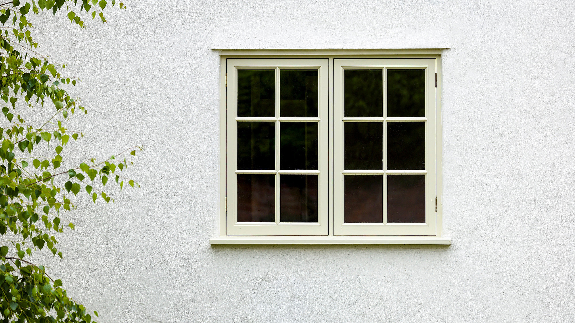 Photograph of a window in a white wall of a residential home