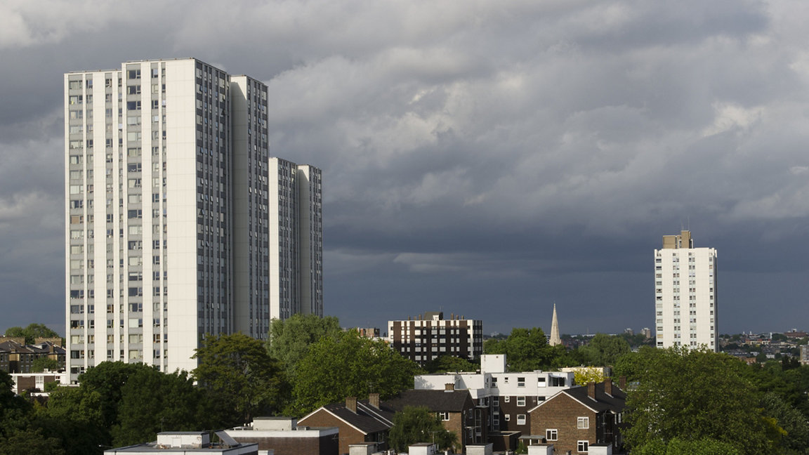High rise and low rise buildings against dark sky