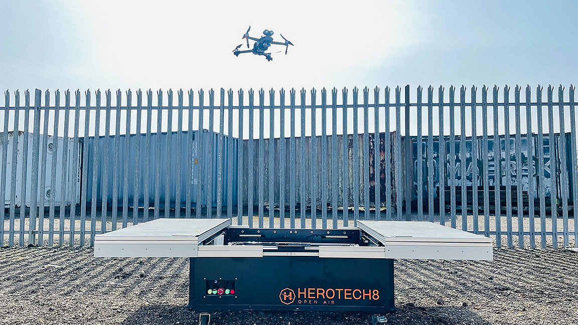 Drone above corrugated iron fence