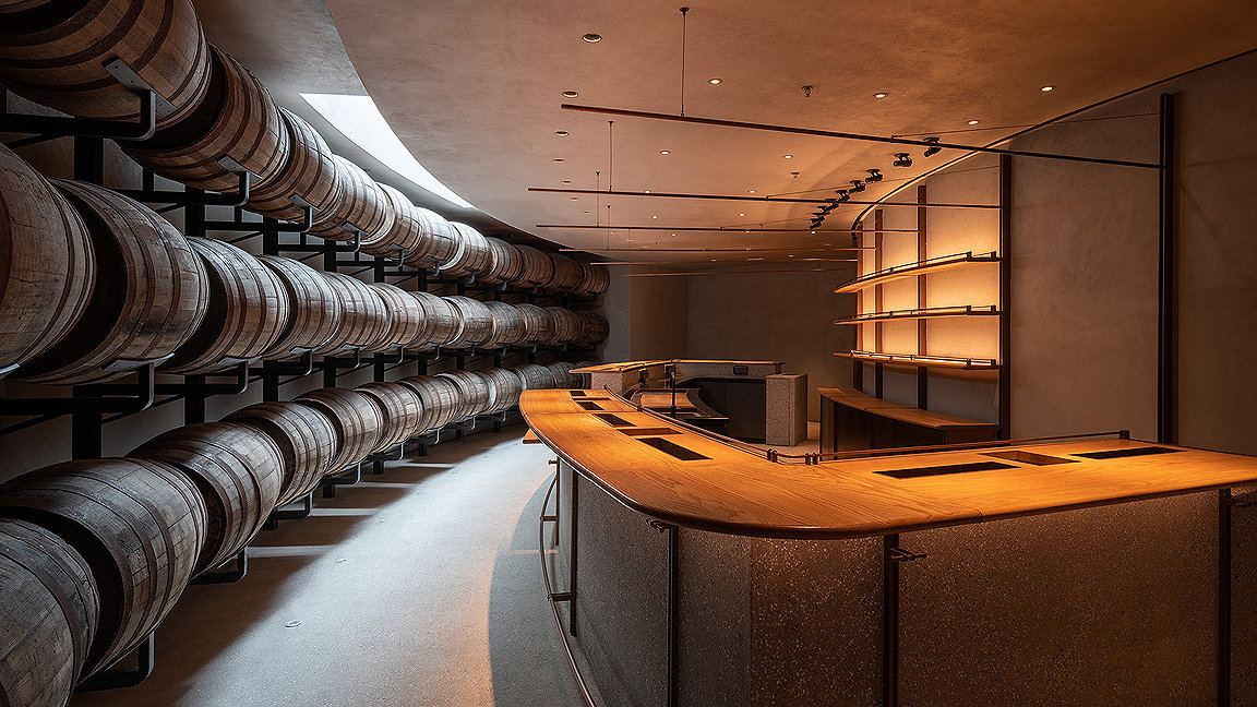 Whisky barrels along curved wall 