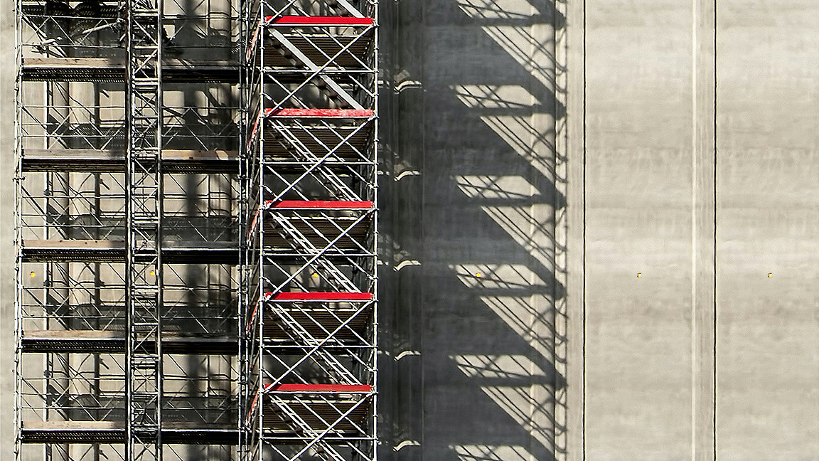 Scaffolding going up side of concrete building