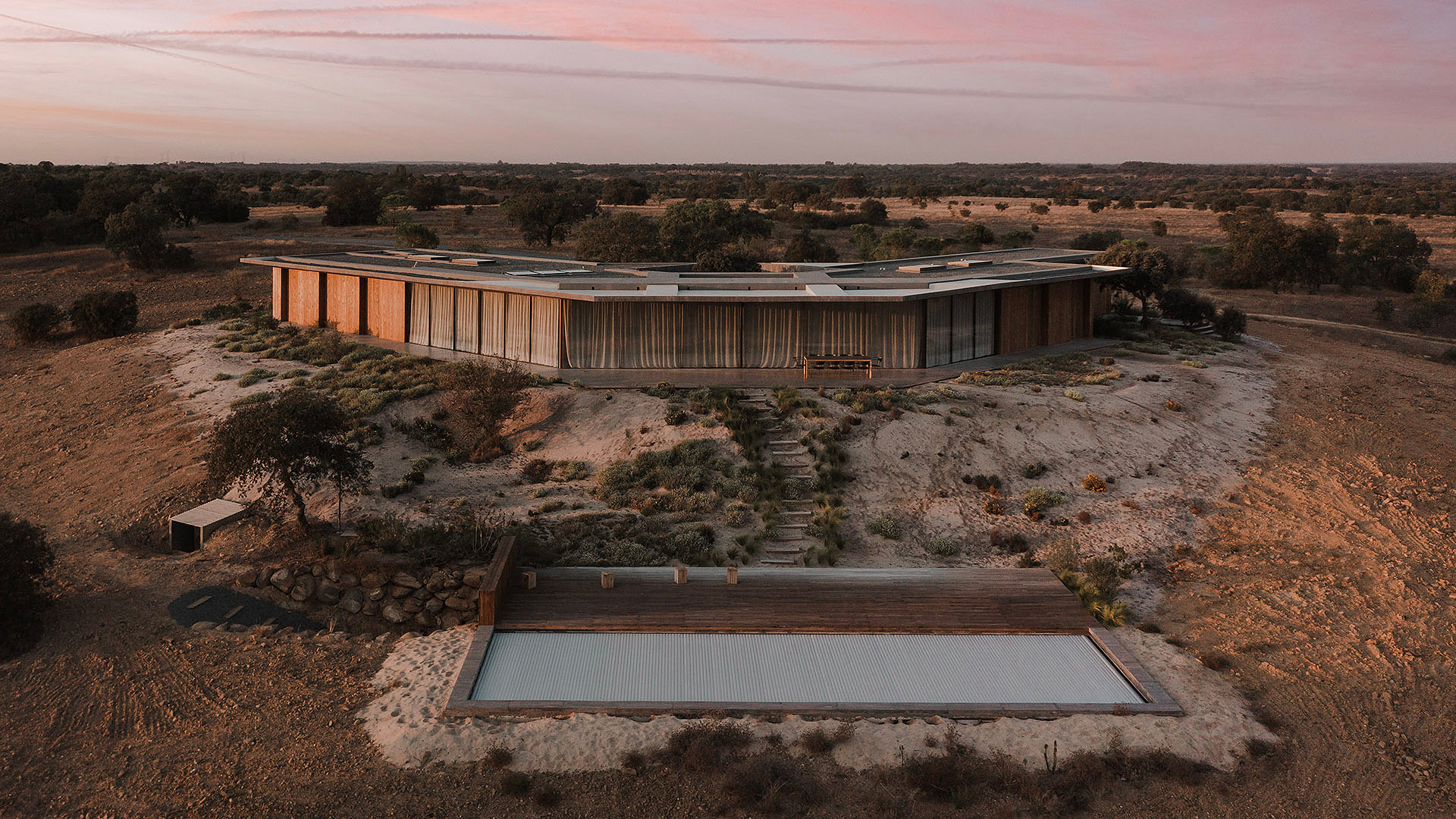 Wooden building amongst desert at sunset purple sky