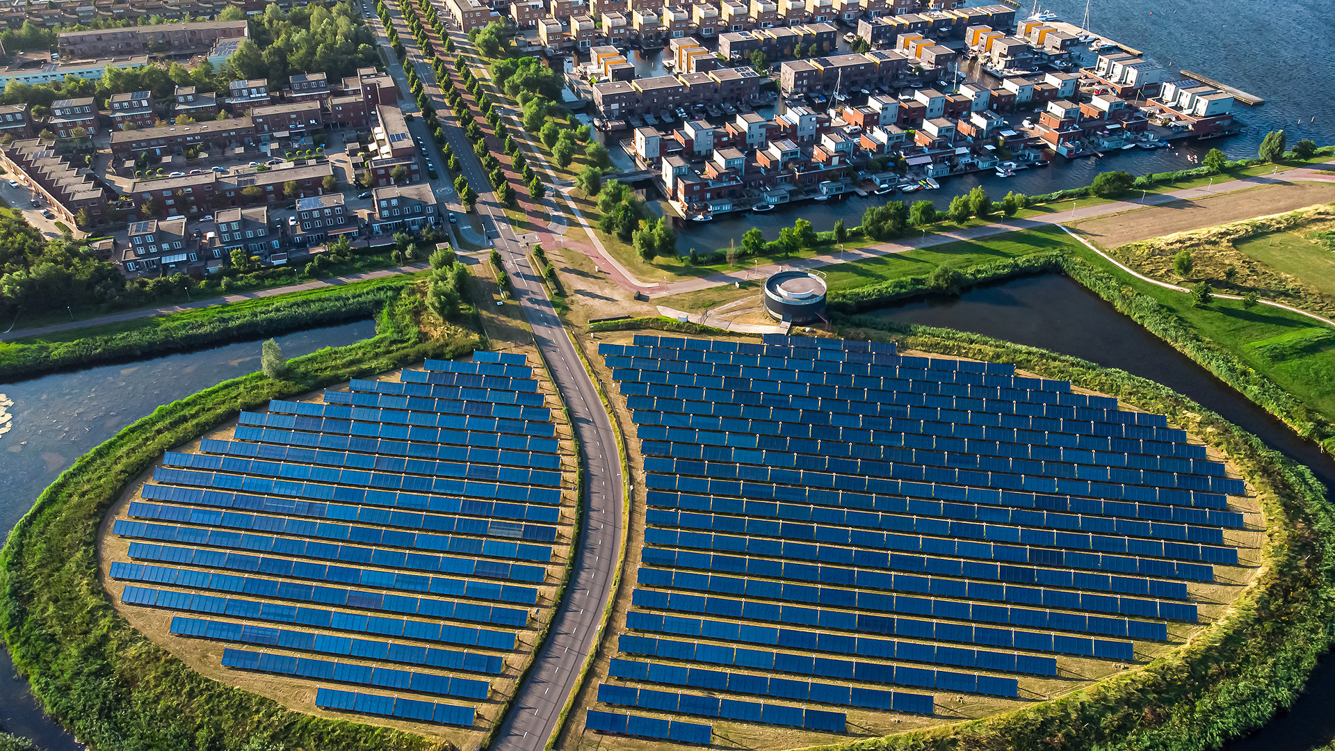 Aerial view of solar panel island next to group of buildings