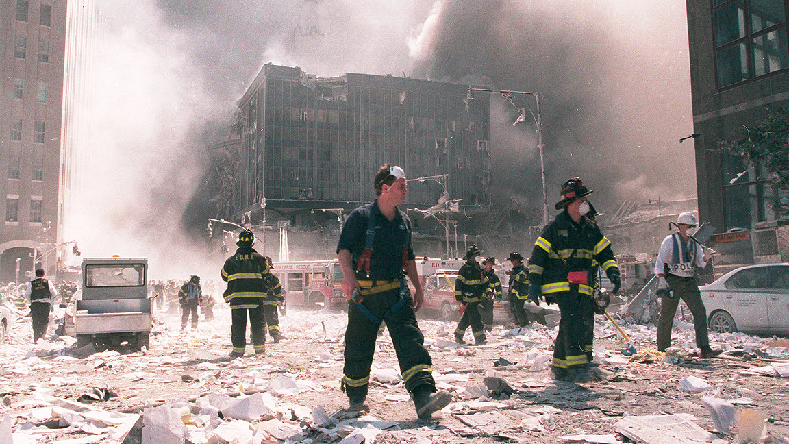 Firefighters walking in rubble from 9 11 attack