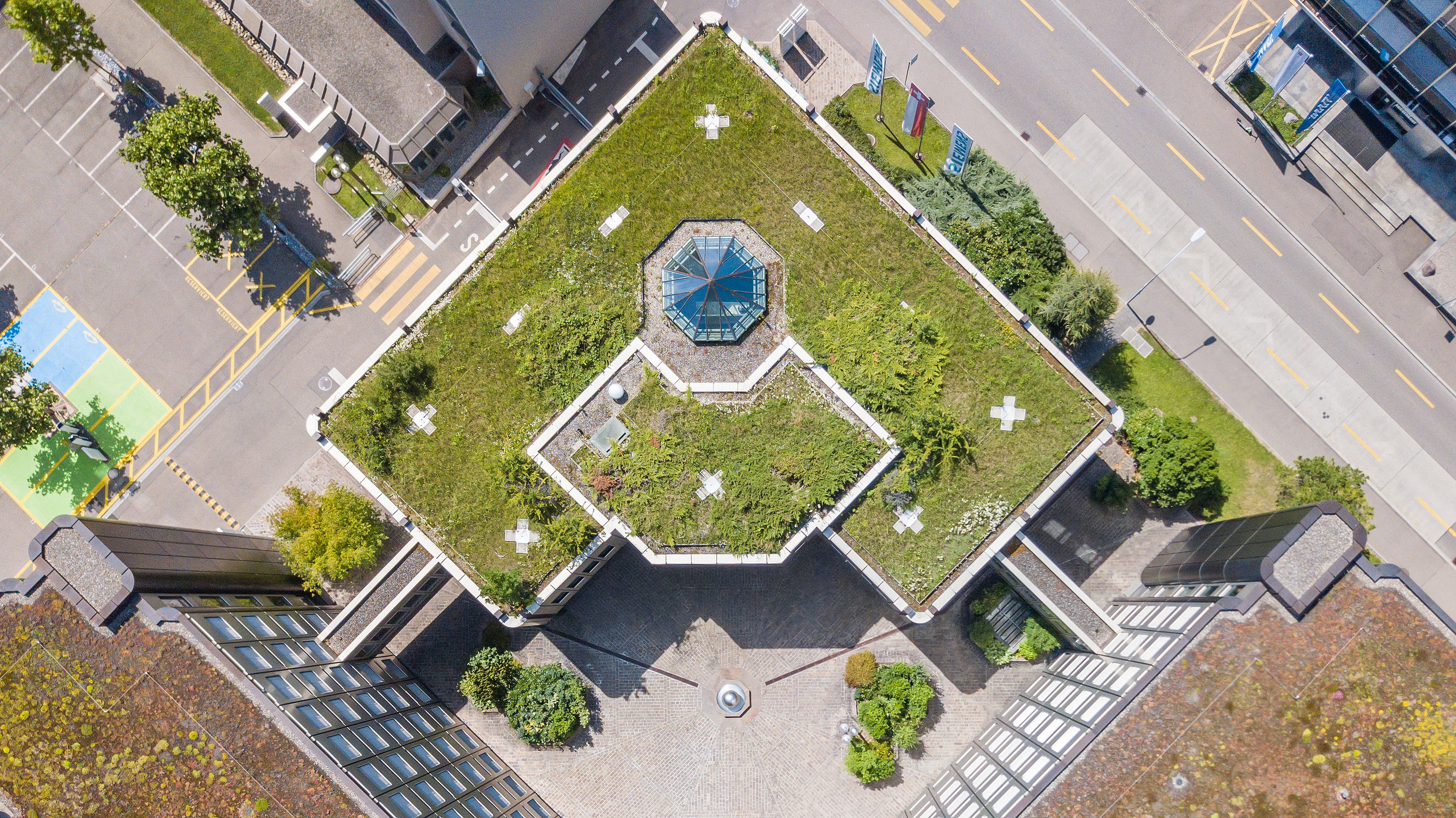 Overhead photo of high rise building with grass roof