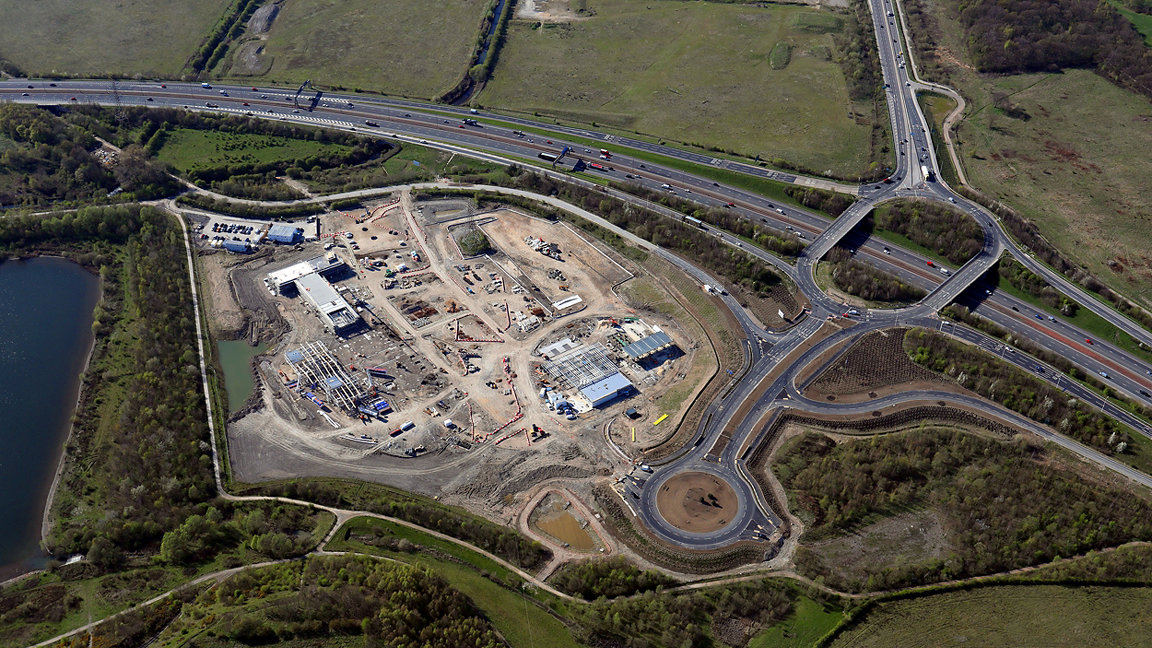 overhead shot of construction site next to a motorway