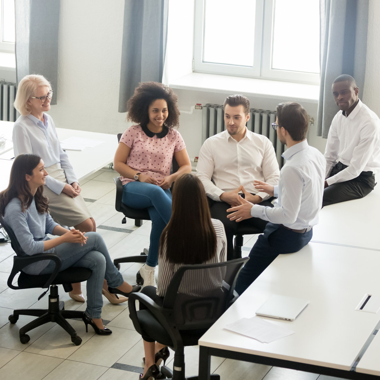 A man on a laptop in a meeting room