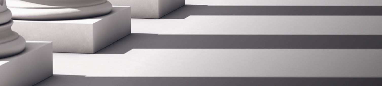 A row of large white pillars casting shadows