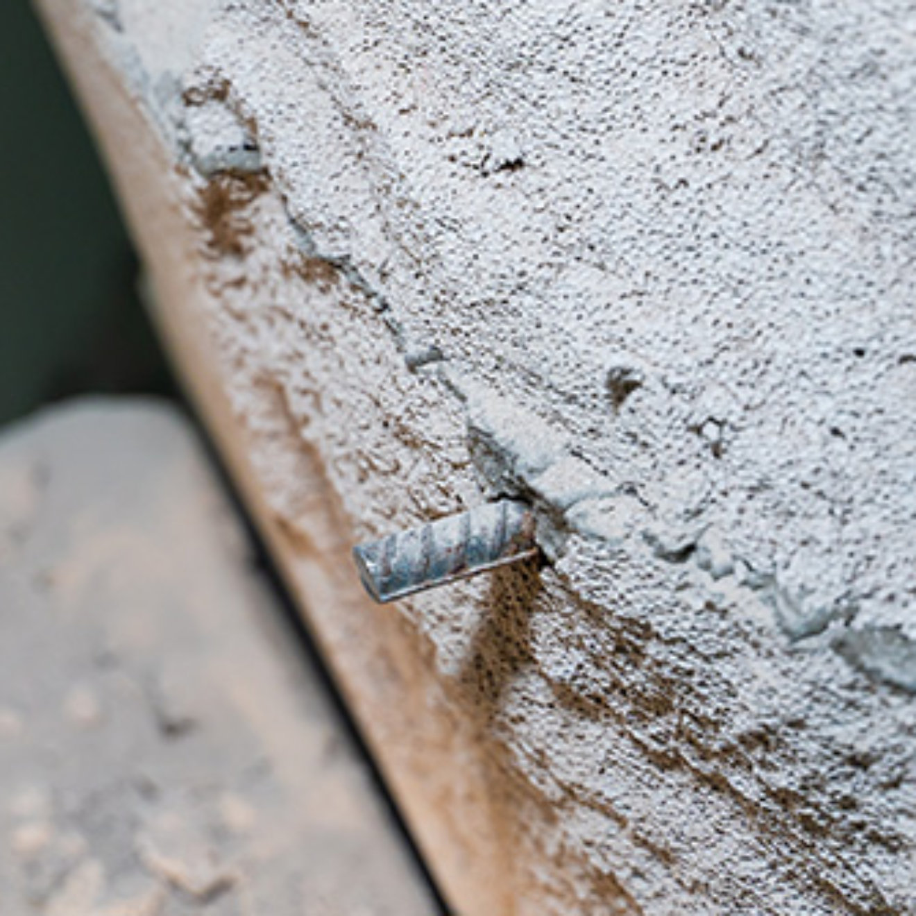 The wall of aerated concrete bricks is cut through close-up. Metal reinforcement in a gas block wall