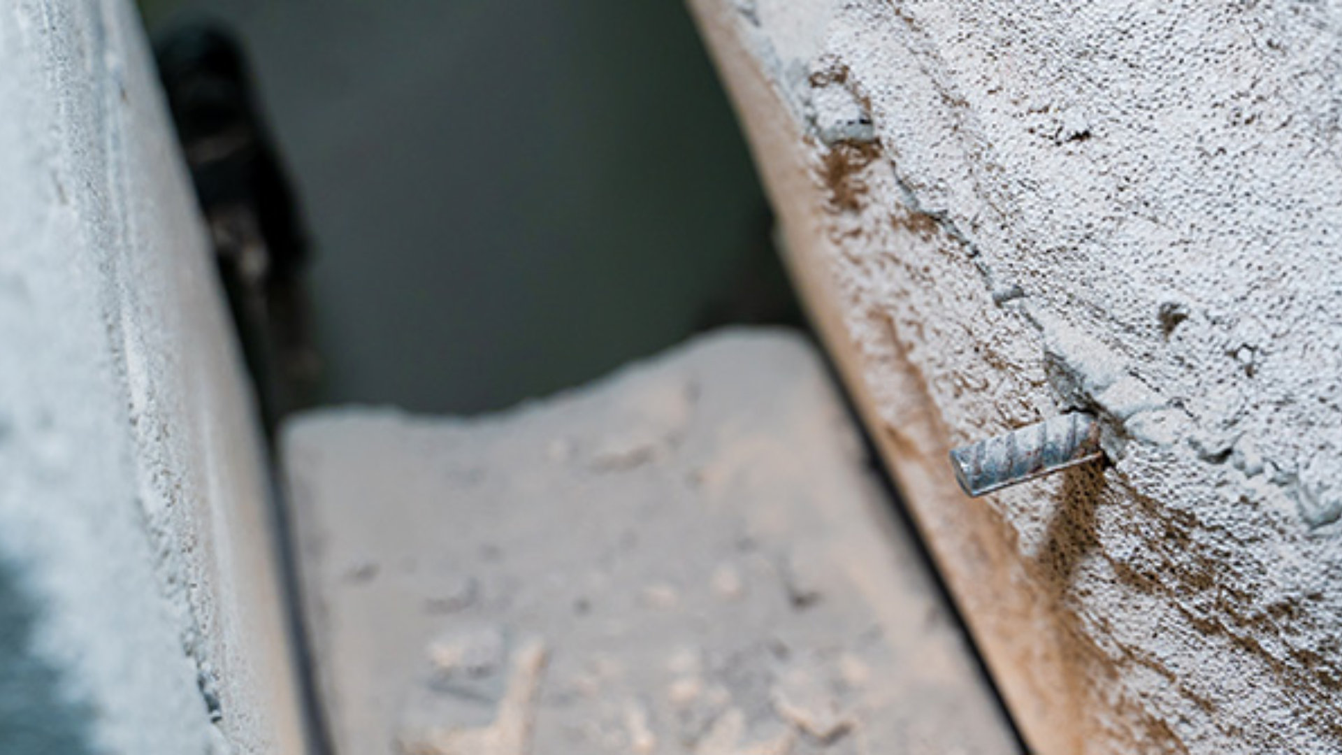 The wall of aerated concrete bricks is cut through close-up. Metal reinforcement in a gas block wall