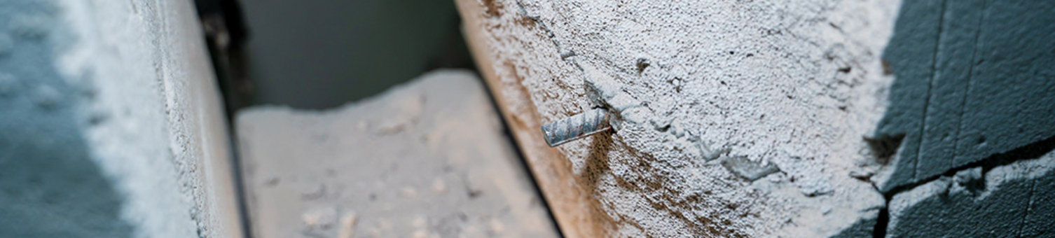 The wall of aerated concrete bricks is cut through close-up. Metal reinforcement in a gas block wall