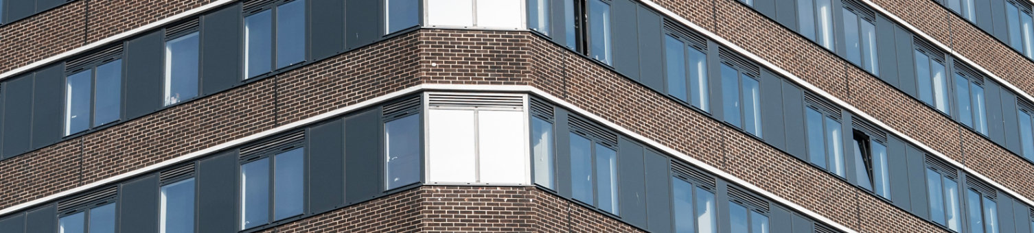 Corner of tall building with windows
