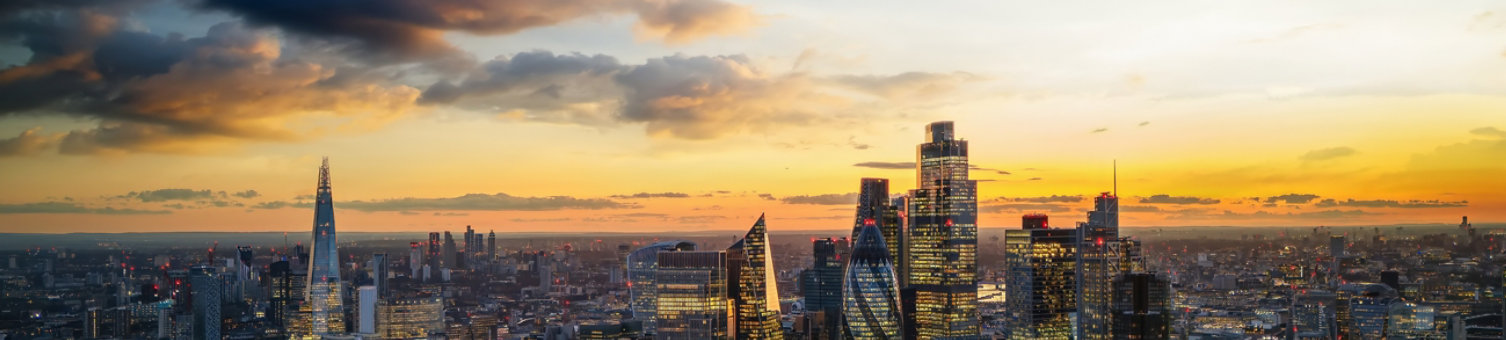 Panoramic aerial view of the illuminated skyline at the City of London, England, during dusk