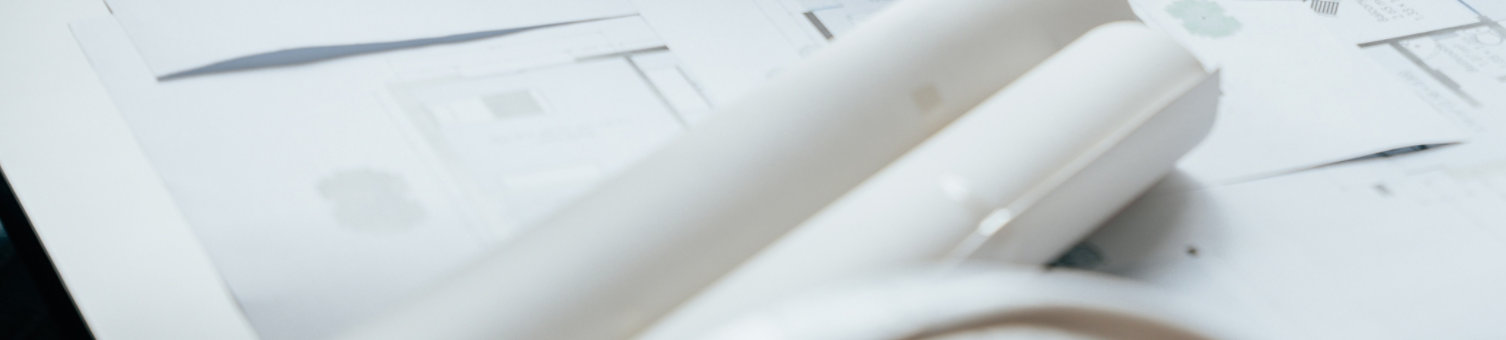 A close up of a surveyor, architect or engineer, working on drawings