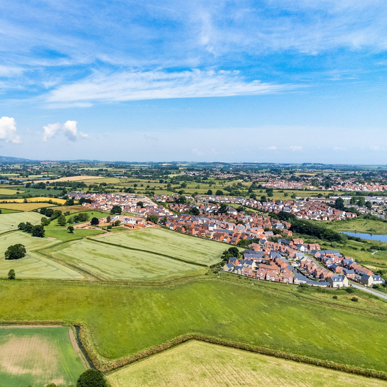 Fields and houses in Somerset, England, from a drone