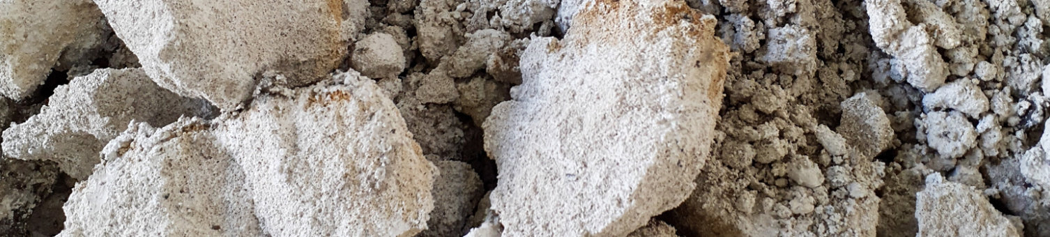 Close-up of RAAC concrete debris with various sized fragments. Reinforced autoclaved aerated concrete demolition waste.
