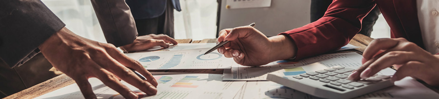 Business People Meeting using laptop computer,calculator,notebook,stock market chart paper for analysis Plans to improve quality next month. Conference Discussion Corporate Concept..