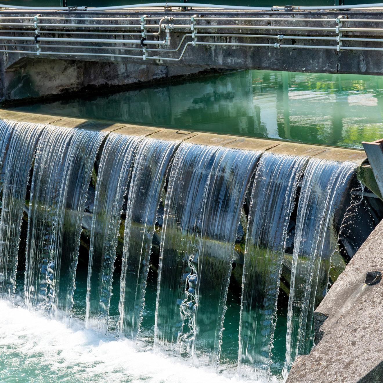 Treviso, Venetien - Italy - 06-13-2021: Close-up of an industrial water locks amidst greenery, part of Treviso historic water control systems