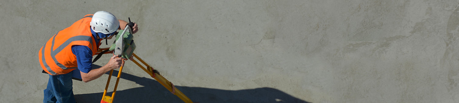 Two surveyers working from a top down view on dirt