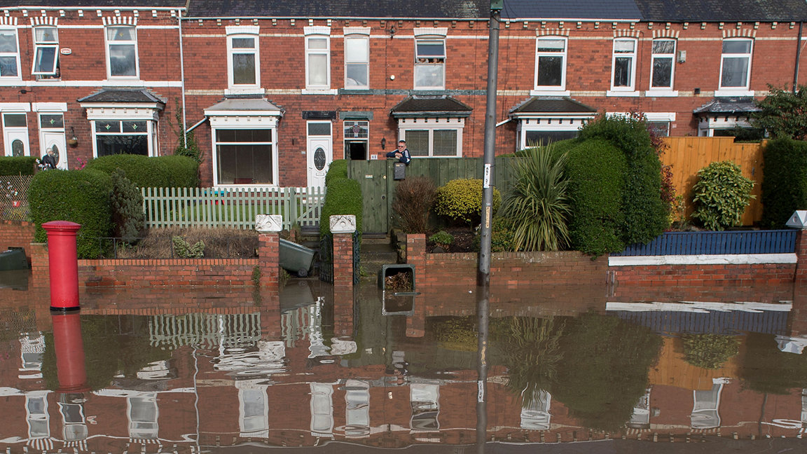 Terraced houses in Middlesbrough reflected in floodwater outside their properties