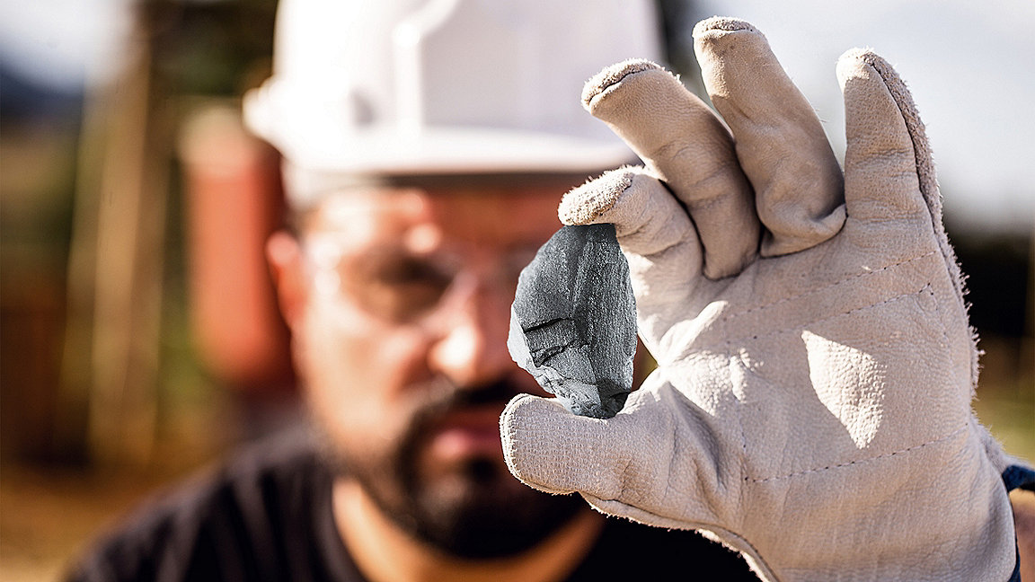 Miner holding piece of ore