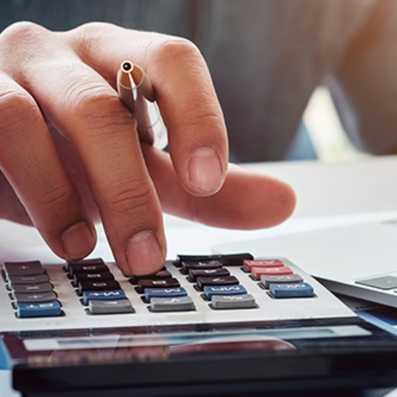 Business accounting concept, Business man using calculator with computer laptop, budget and loan paper in office. 