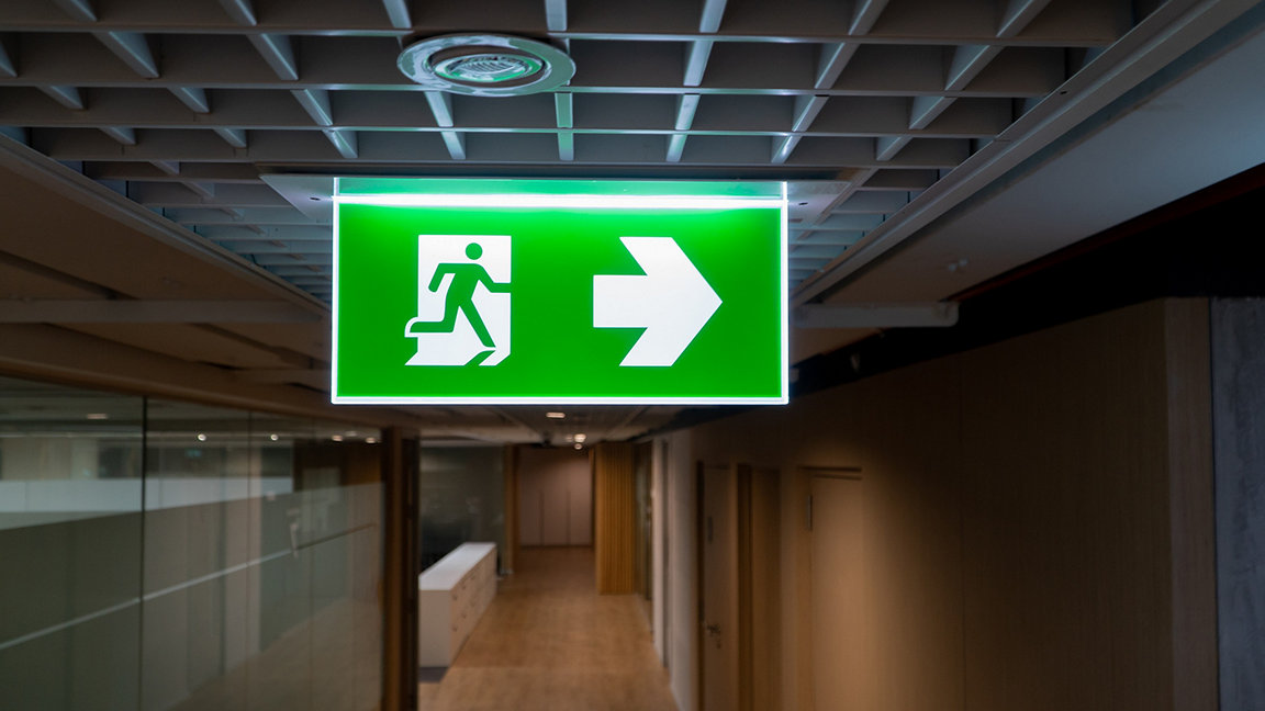 Fire exit sign hanging from ceiling