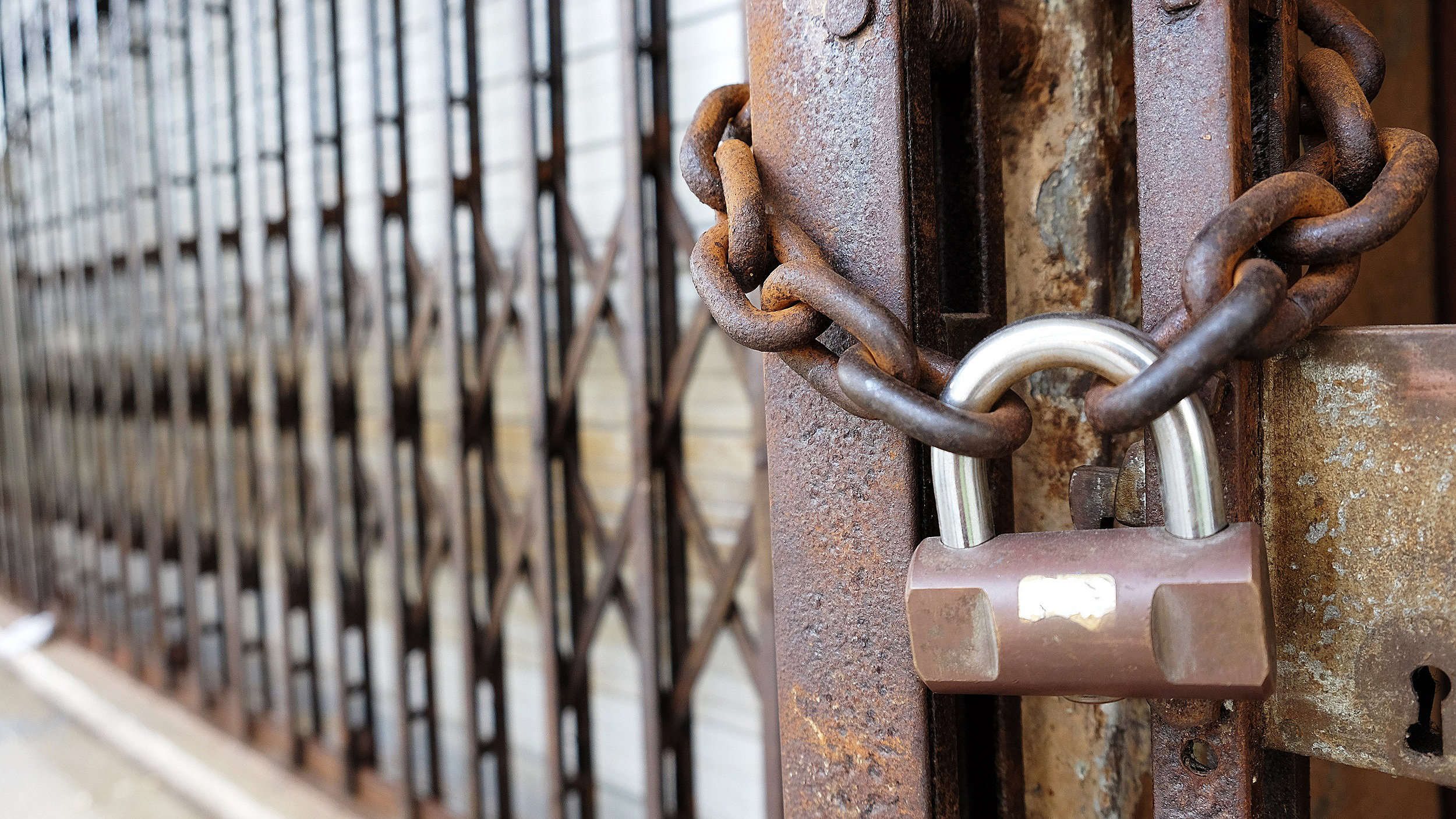 Padlock and chain on locked gate