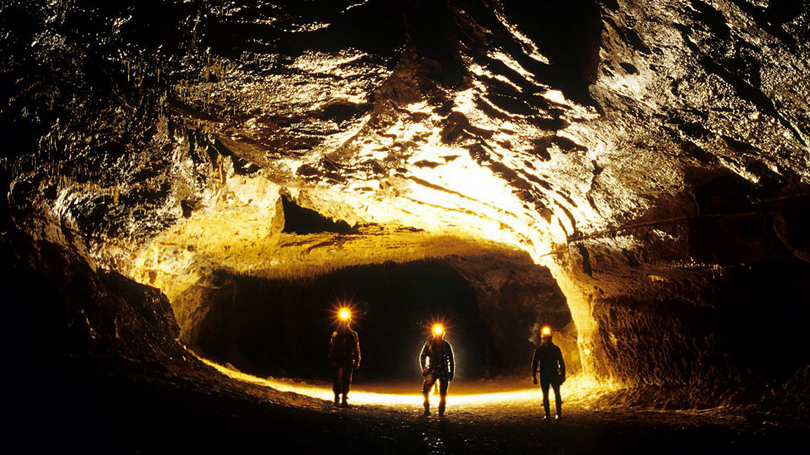 Three participants in the Deep Time study explore inside the Lombrives cave