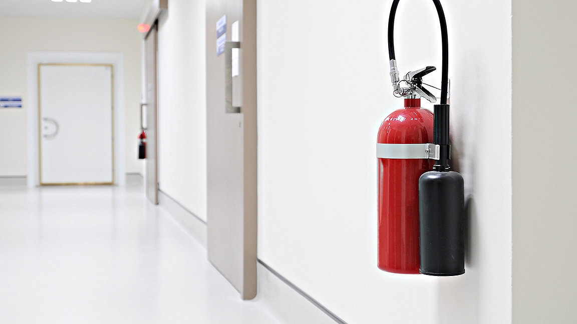 Fire extinguisher on corridor wall