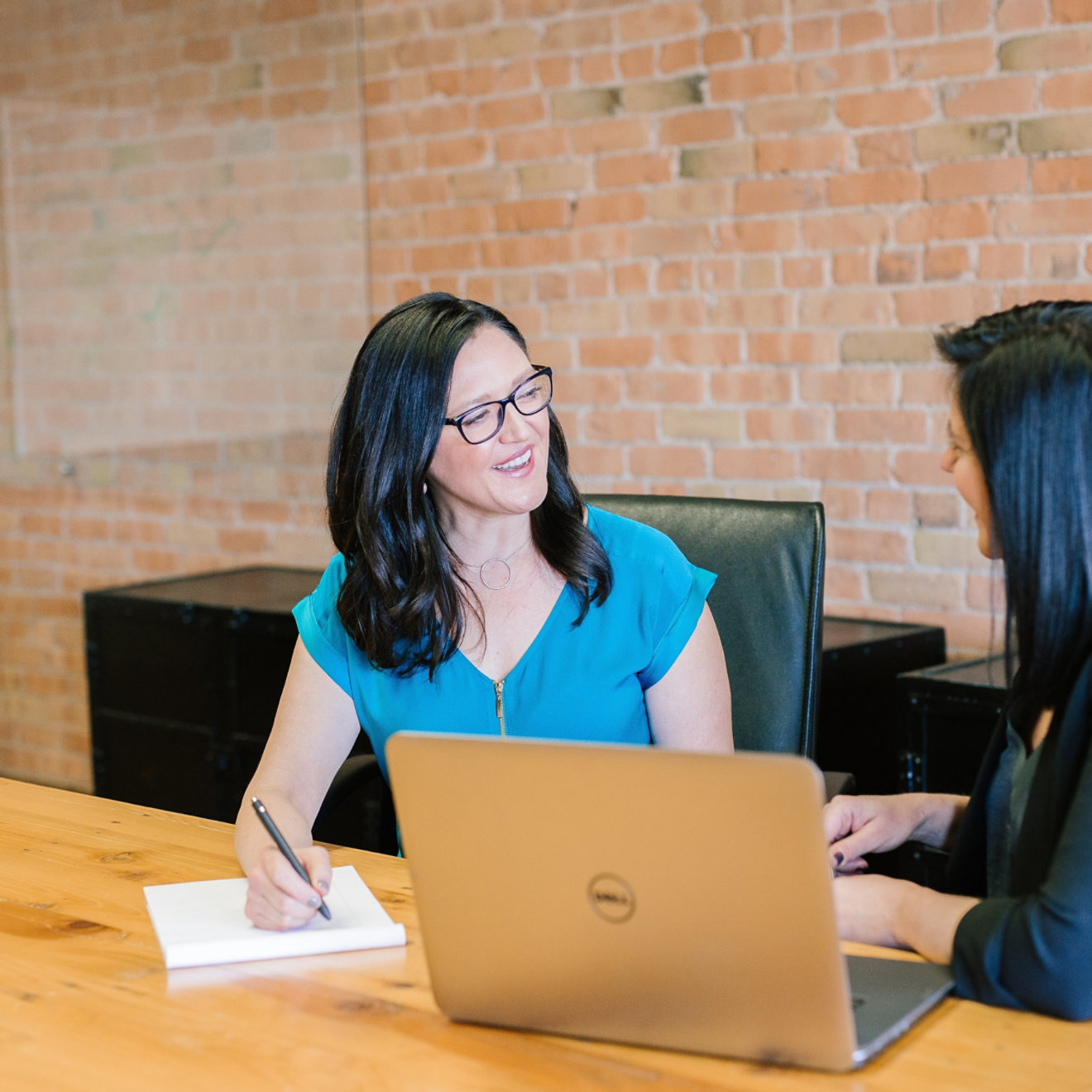 Two women are sat together having a one-to-one meeting