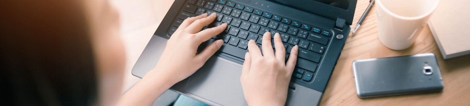 woman typing on laptop at home