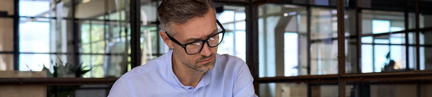A man taking notes at a laptop