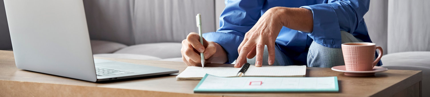 Hands making notes in an office setting