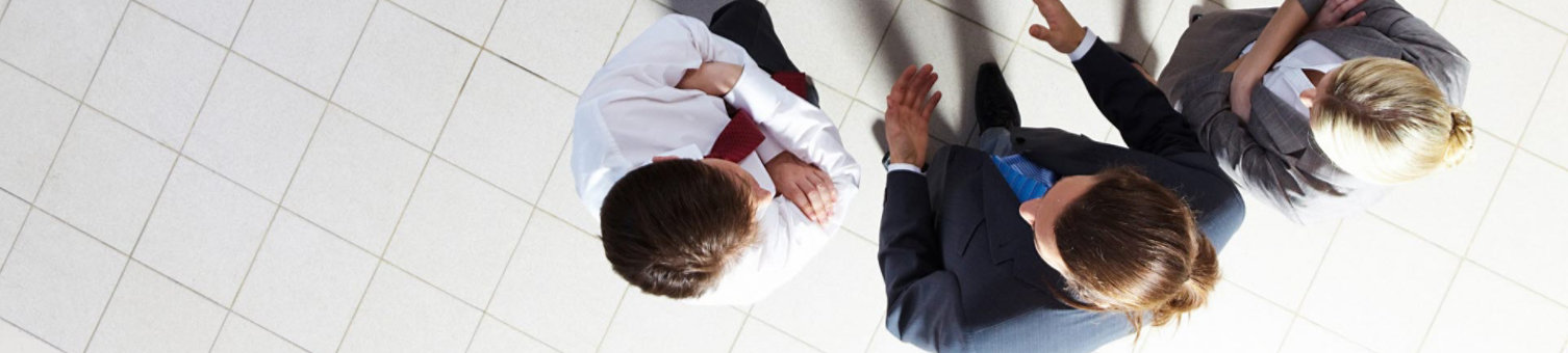 A small group of people meeting and shaking hands as viewed from above