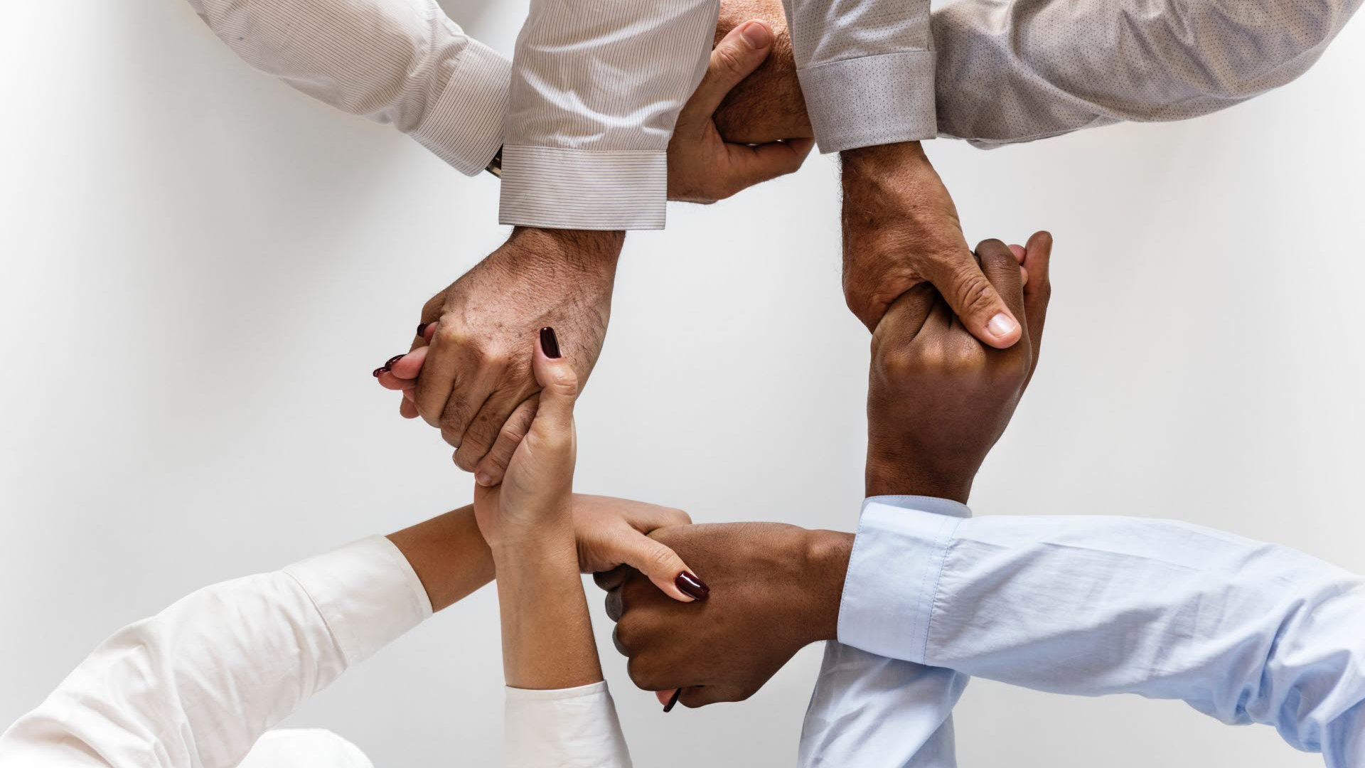 group of diverse people holding hands