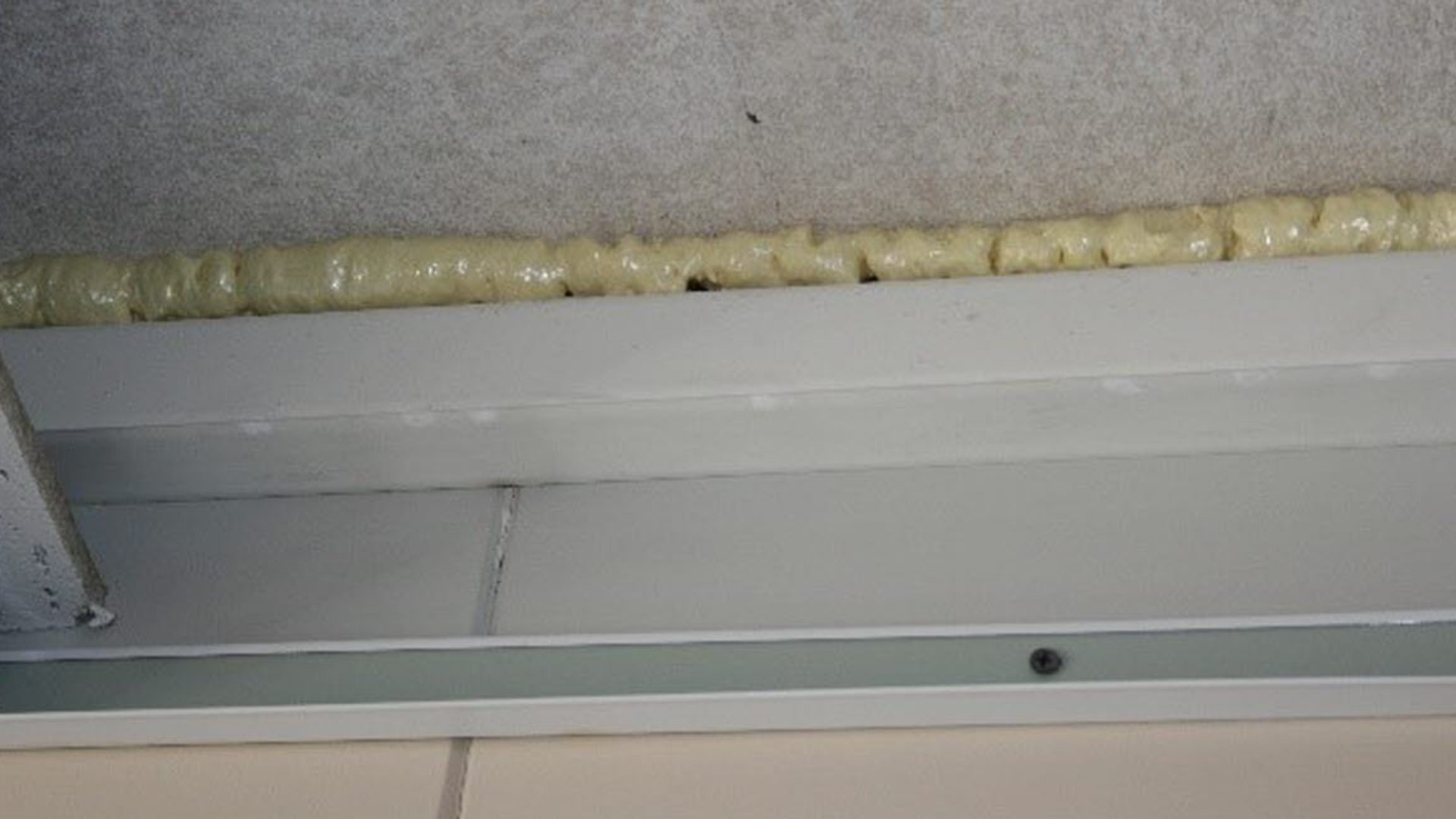 Encapsulated sprayed asbestos identified through use of expanded foam
