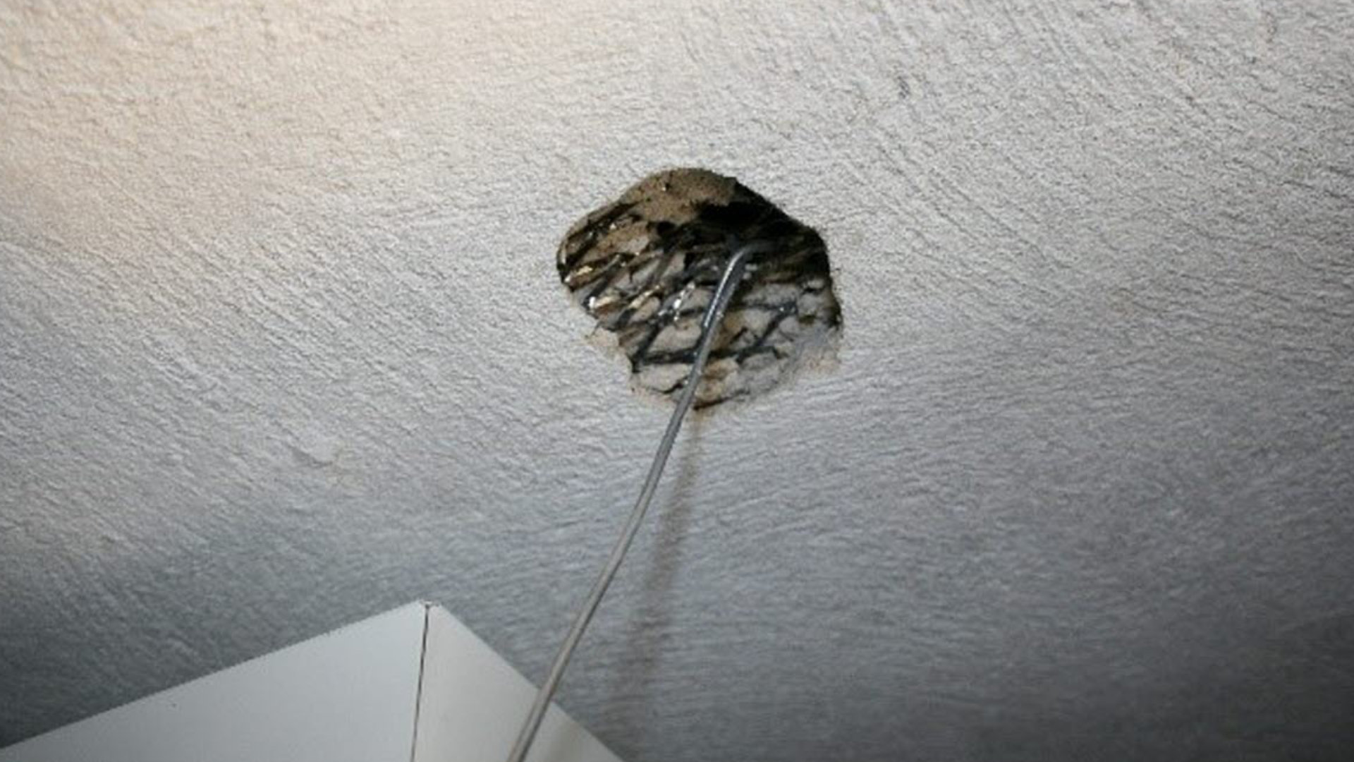 Sprayed asbestos residue on ceiling