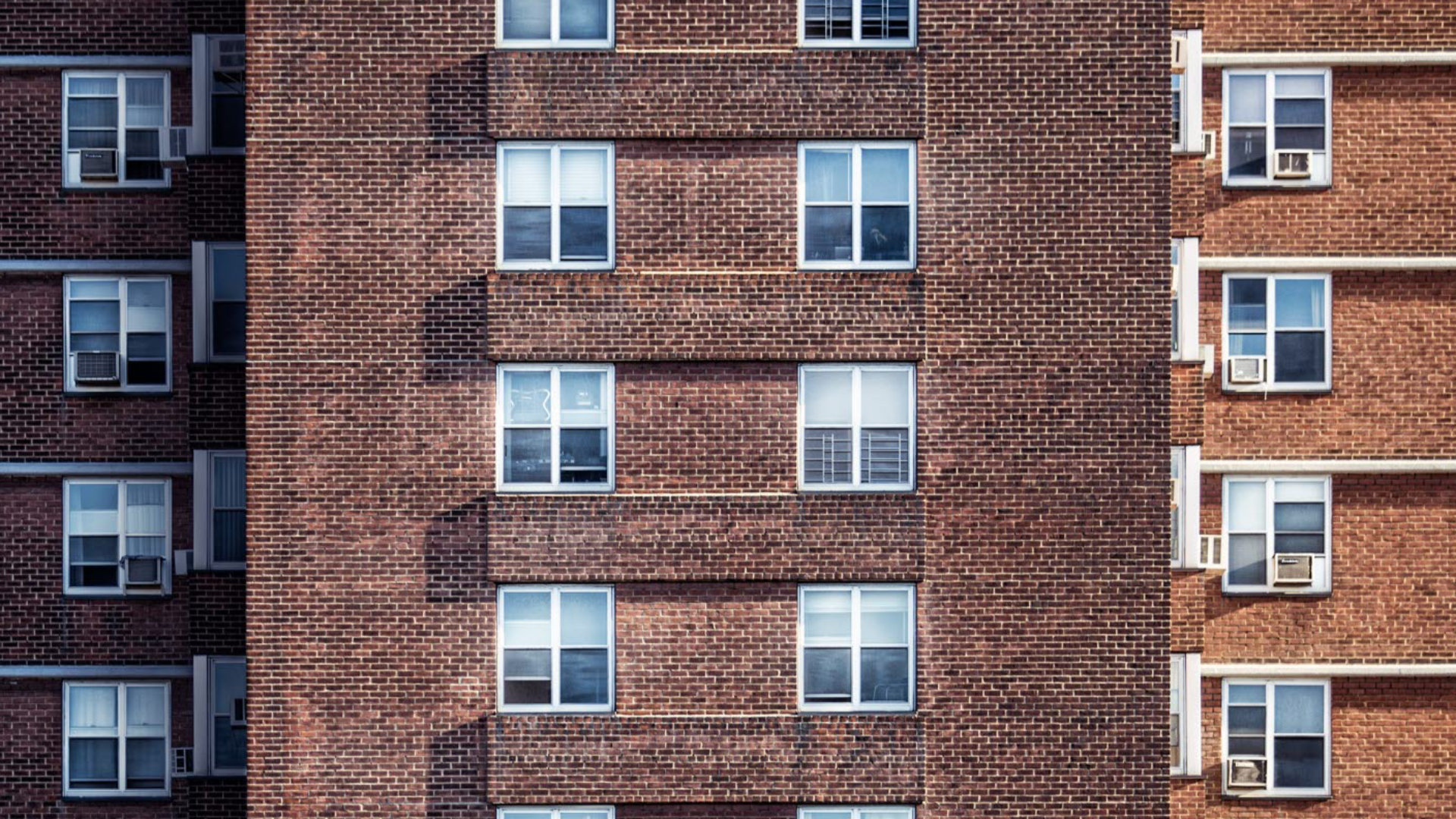 A brick housing block with small windows