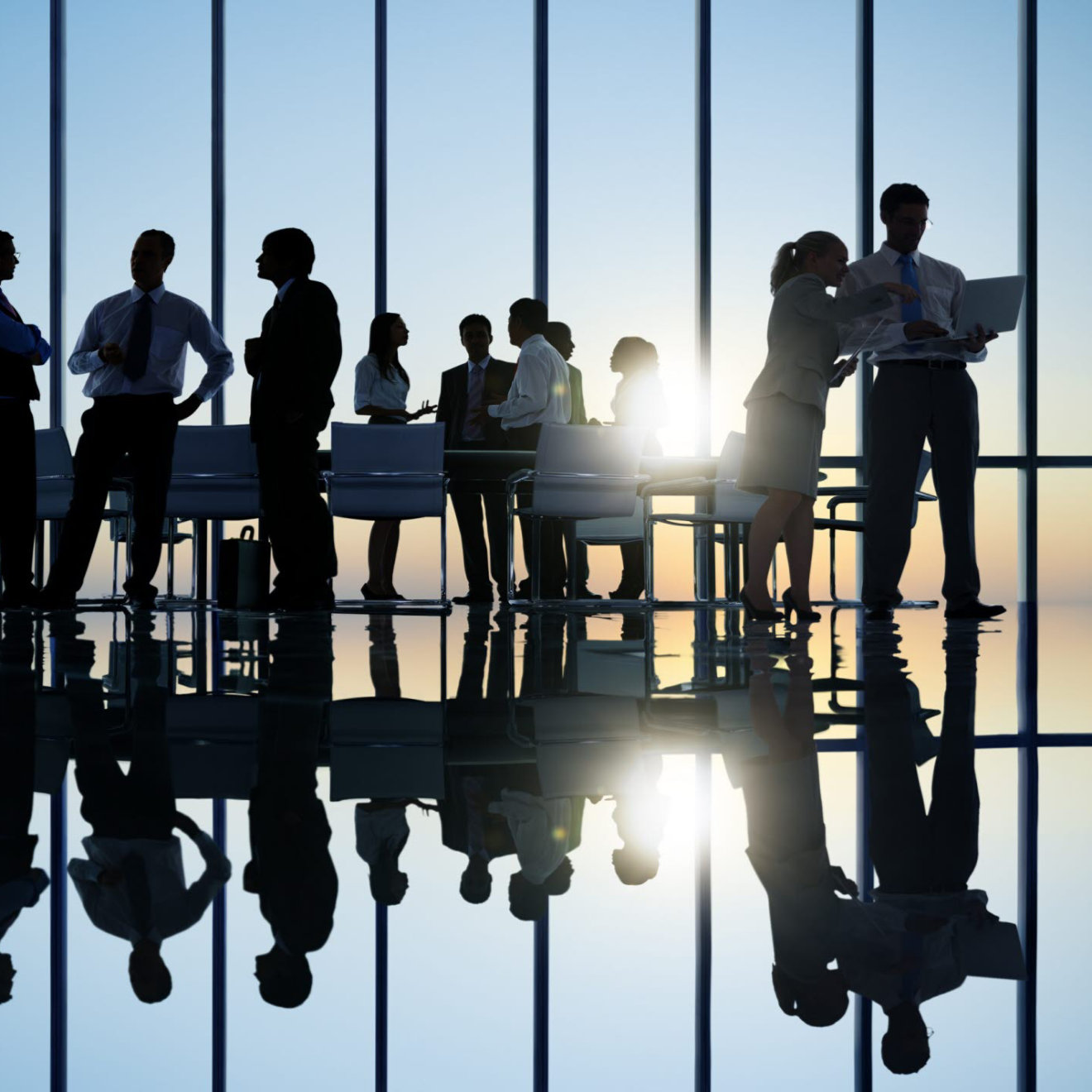 A silhouette of business people holding a meeting 