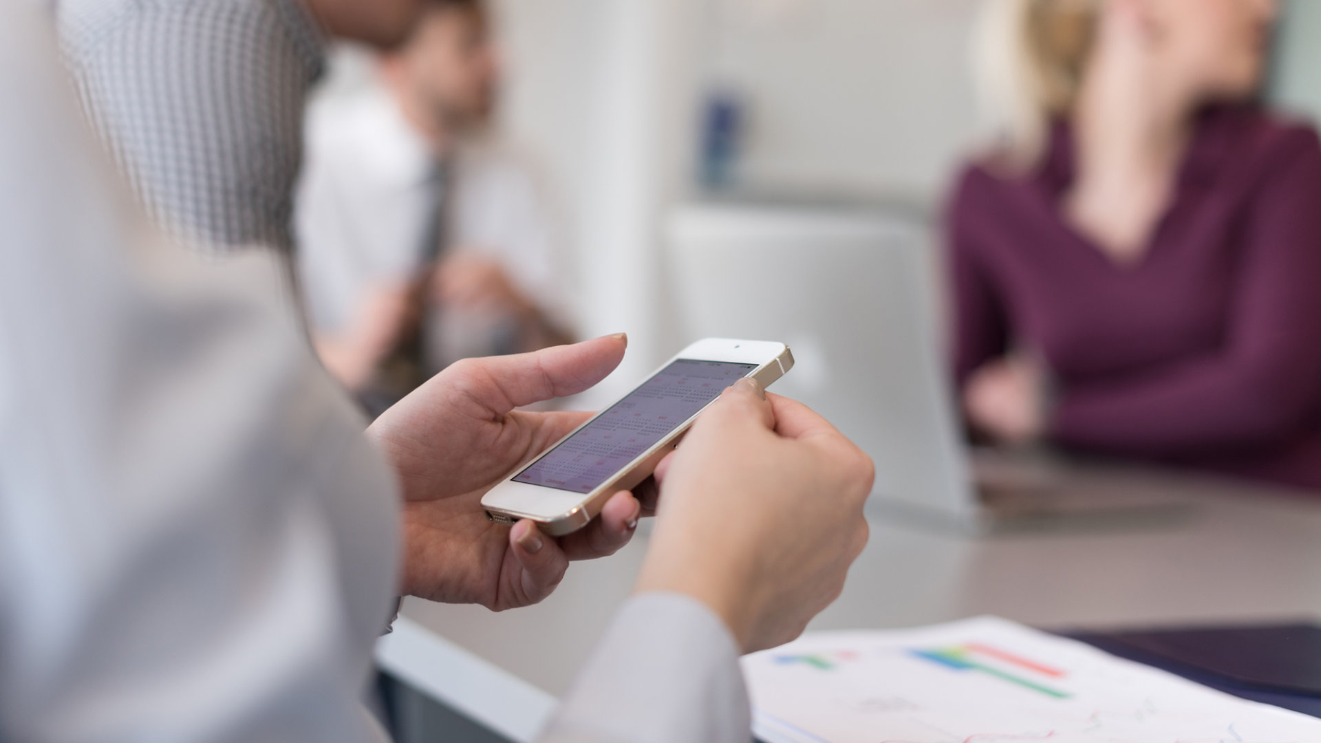 businesswoman with hands on smart phone