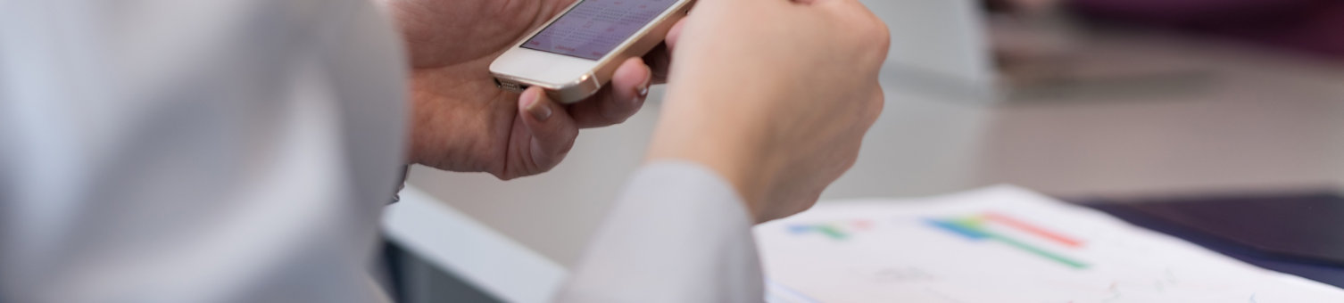businesswoman with hands on smart phone