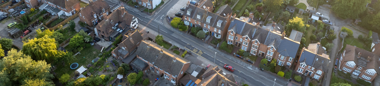 Aerial view of a suburban residential area showing semi-detached houses with gardens