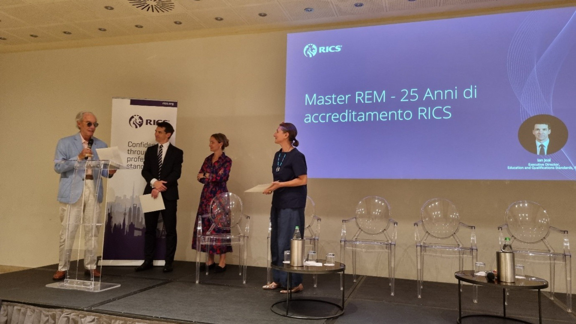Ian Jael, Executive Director Education Standards and Qualifications and Gloria Brocchi MRICS presents Oliviero Tronconi FRICS and Marzia Morena FRICS with certificates of appreciation.