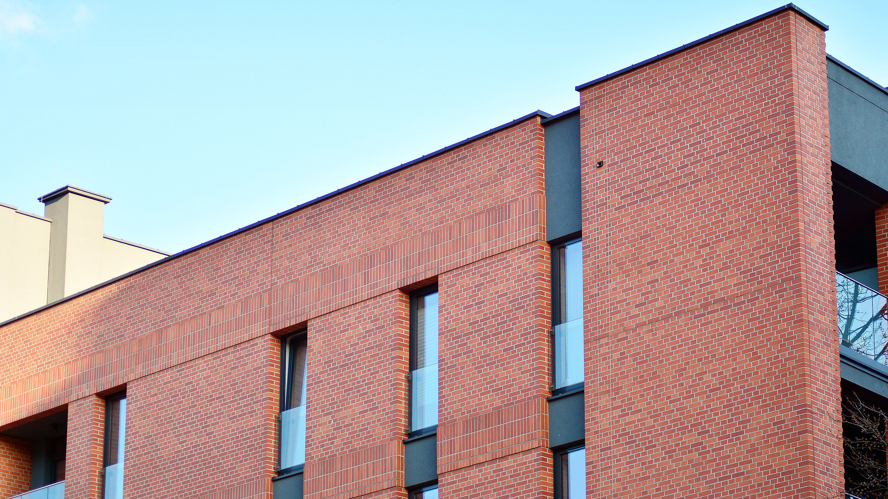 Side view of a modern red brick residential apartment block