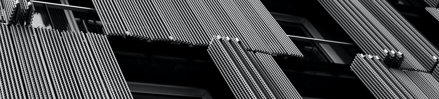 A close up, black and white photo of cladding and windows