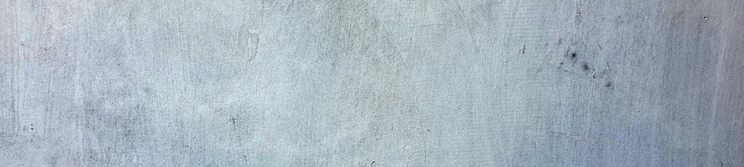 A concrete wall showing a subtle, rough texture.