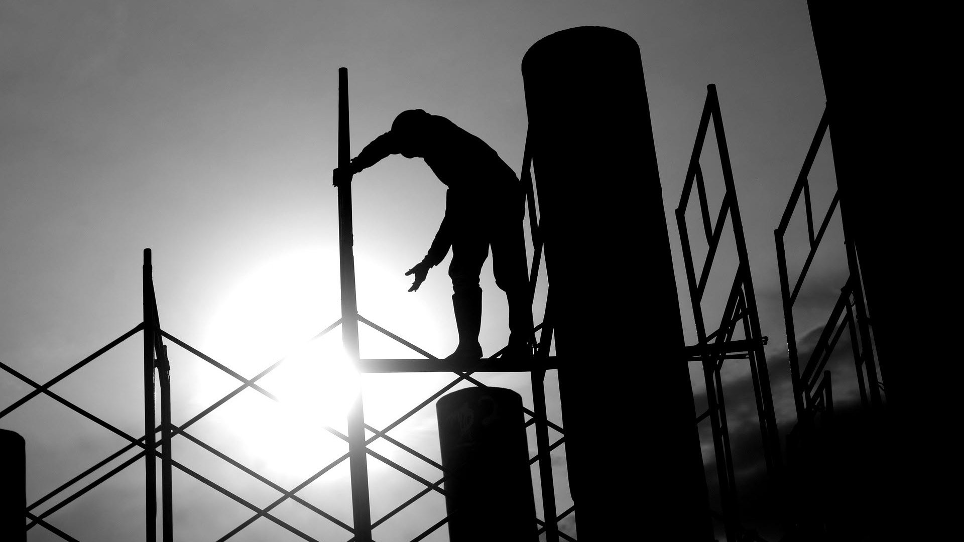 Person working on scaffolding silhouette 